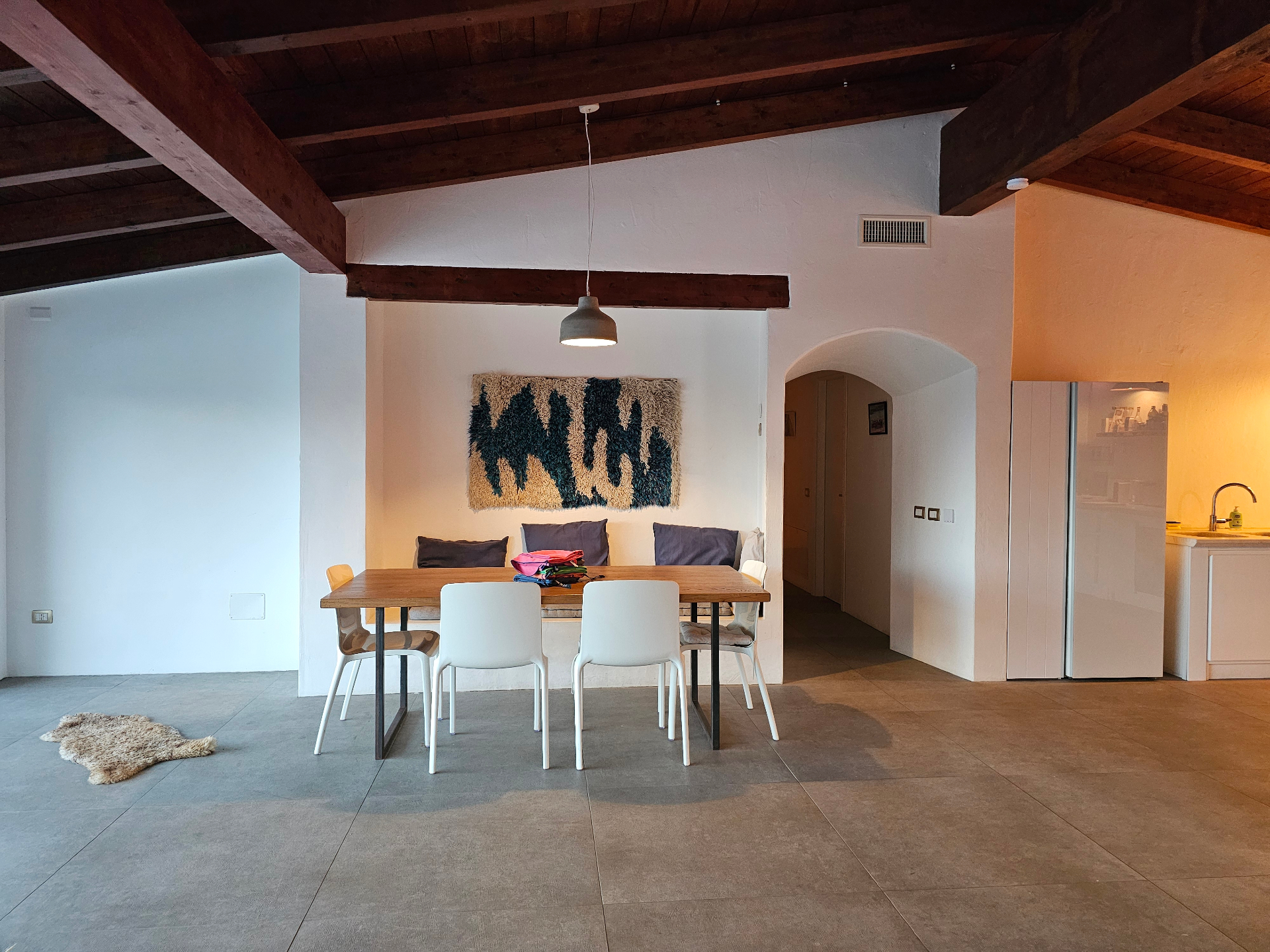 Dining table with Sardinian tapestry in the main living space