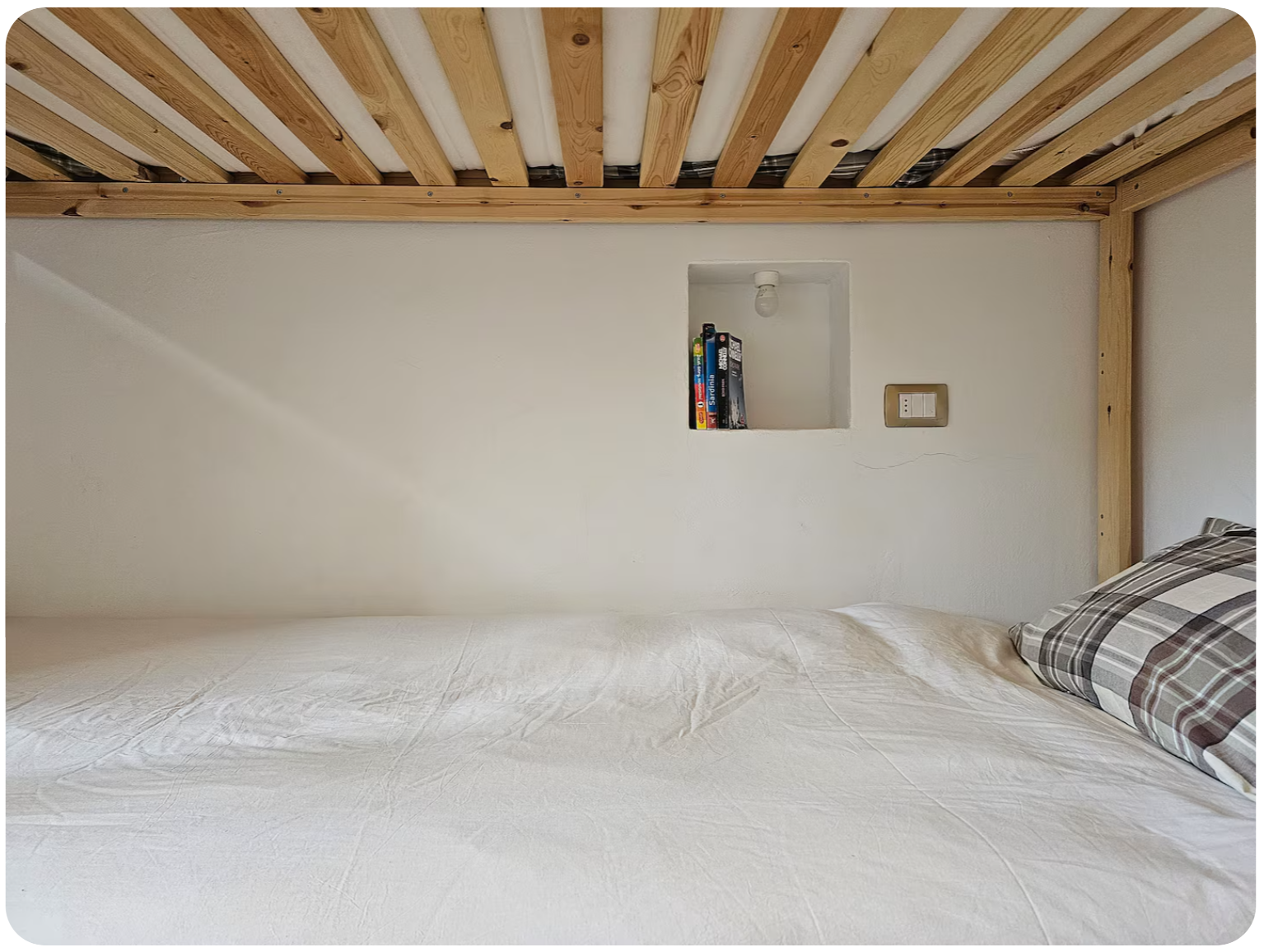 Mezzanine loft bed with wooden beams and reading nook