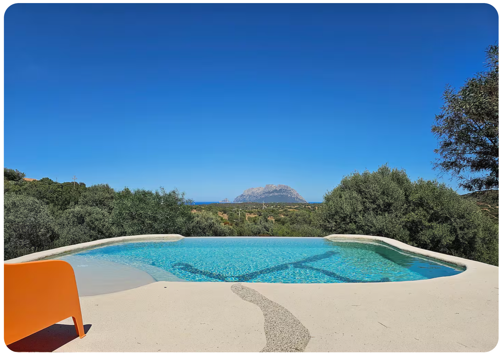 Infinity pool with view of Tavolara island and orange lounger
