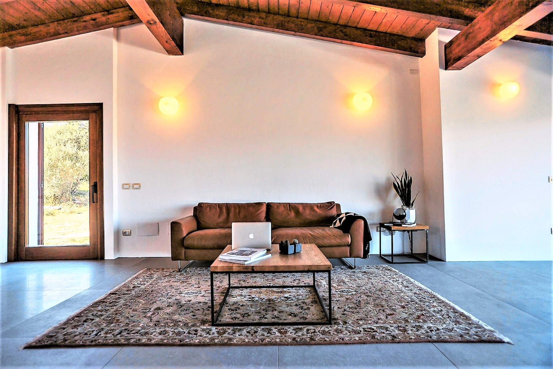Lounge with leather sofa and warm wall lighting